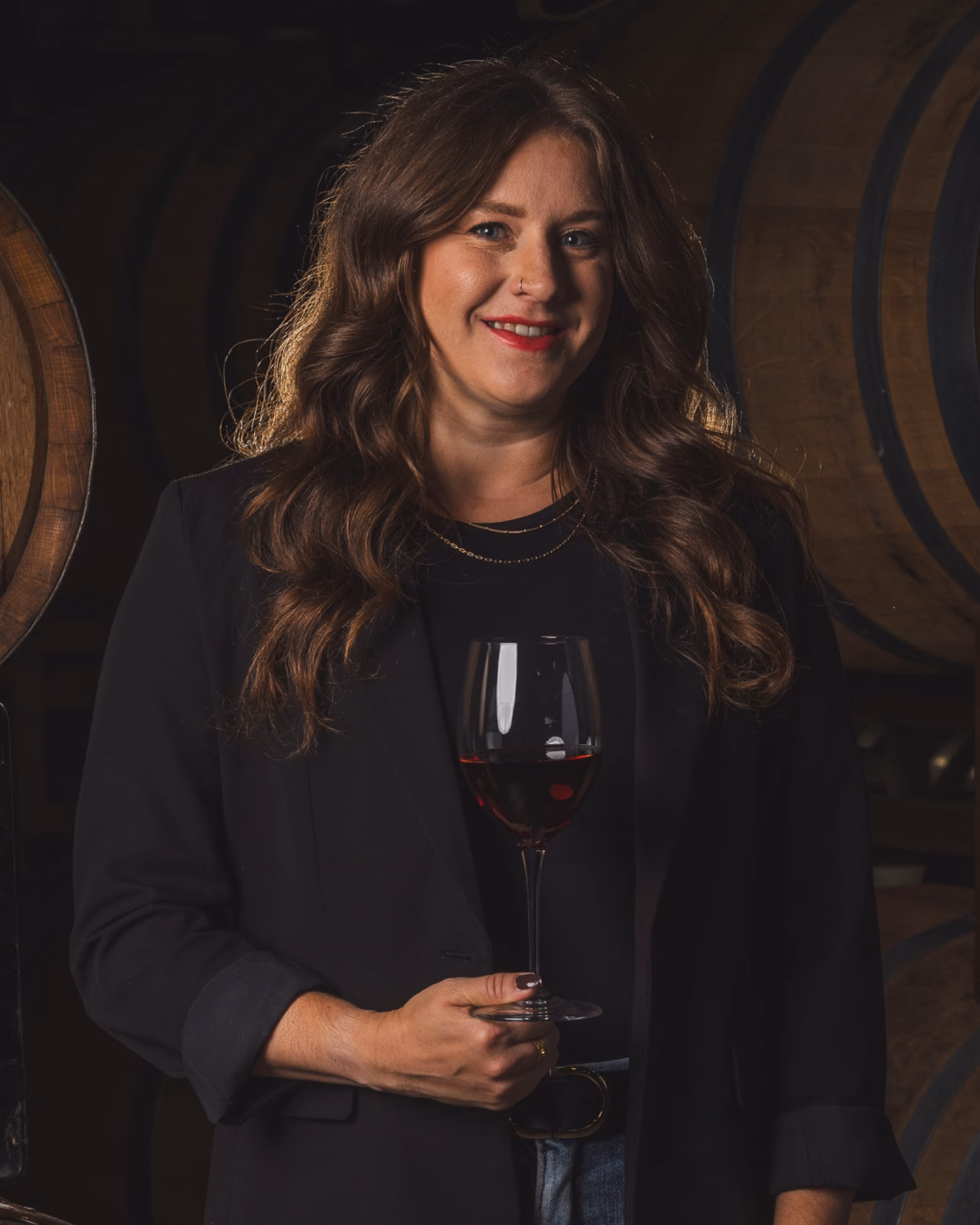 Nicole of Tabor Hill photographed with wine in the cellar