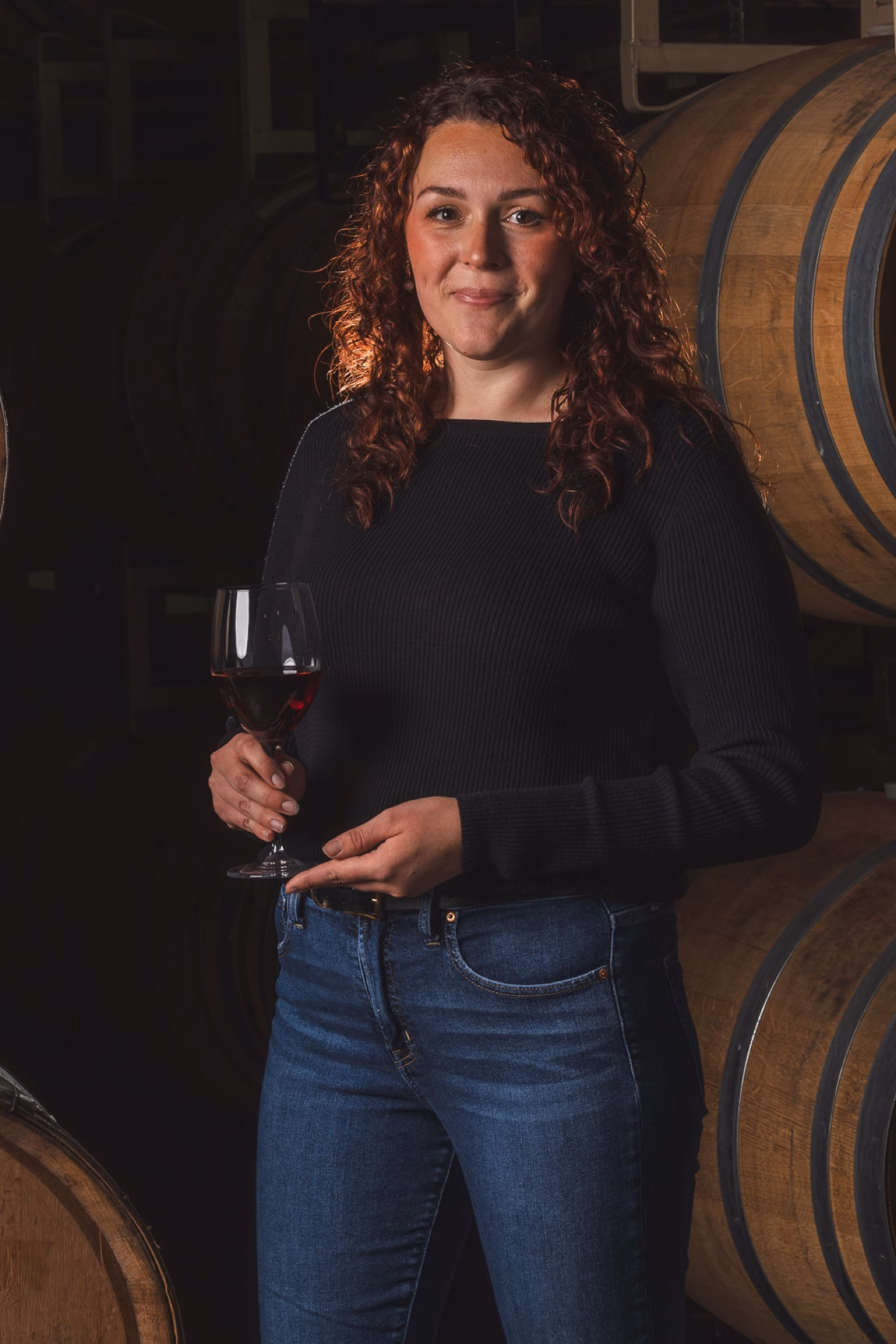 Sage, winemaker at Tabor Hill, photographed in the wine cellar